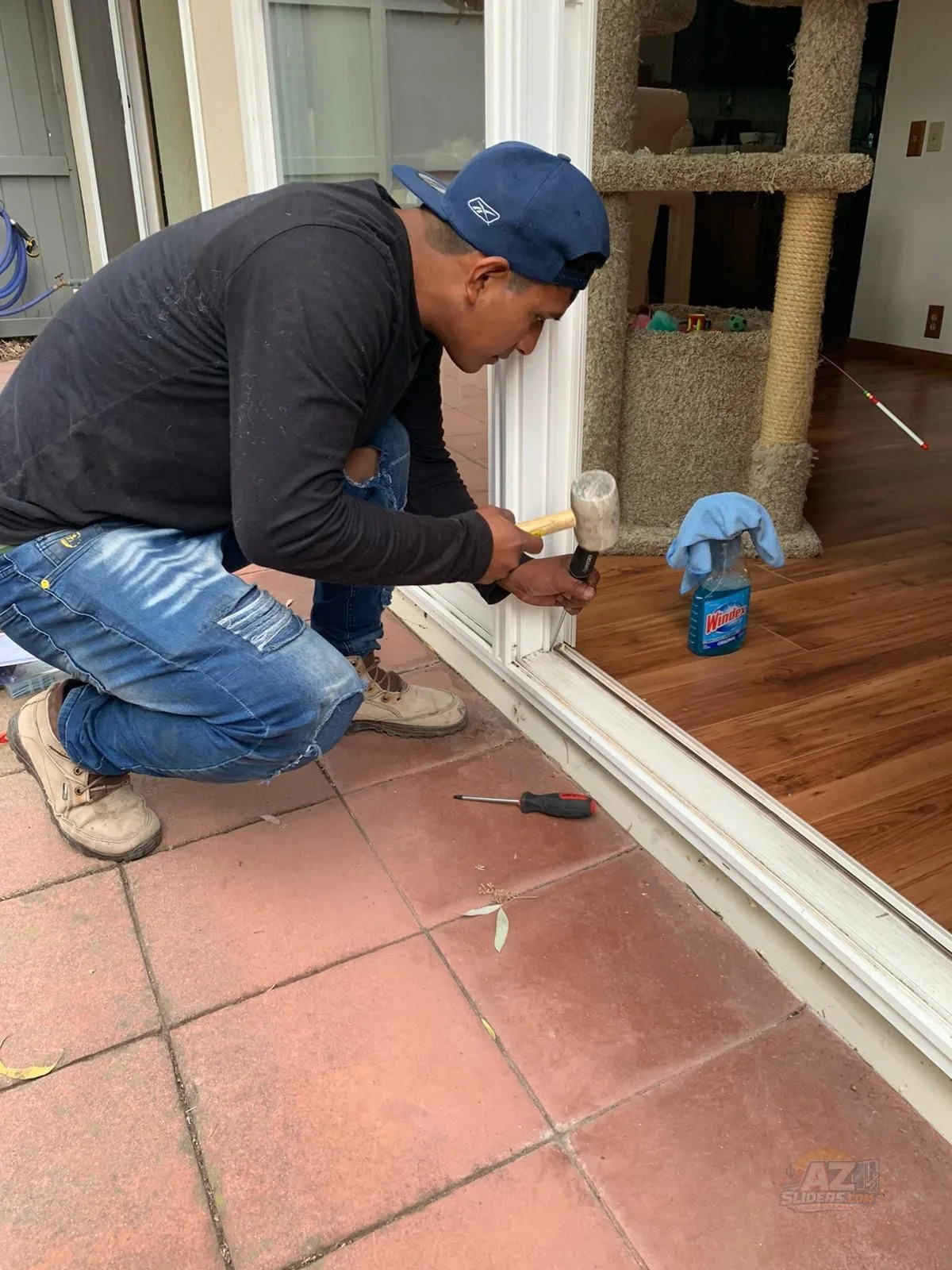 AZSliders technician repairing sliding patio door track on tile patio — Chandler AZ